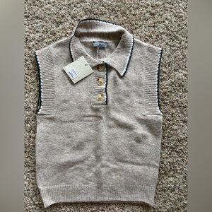 NWT. Super soft sleeveless sweater in beige with brown trim.